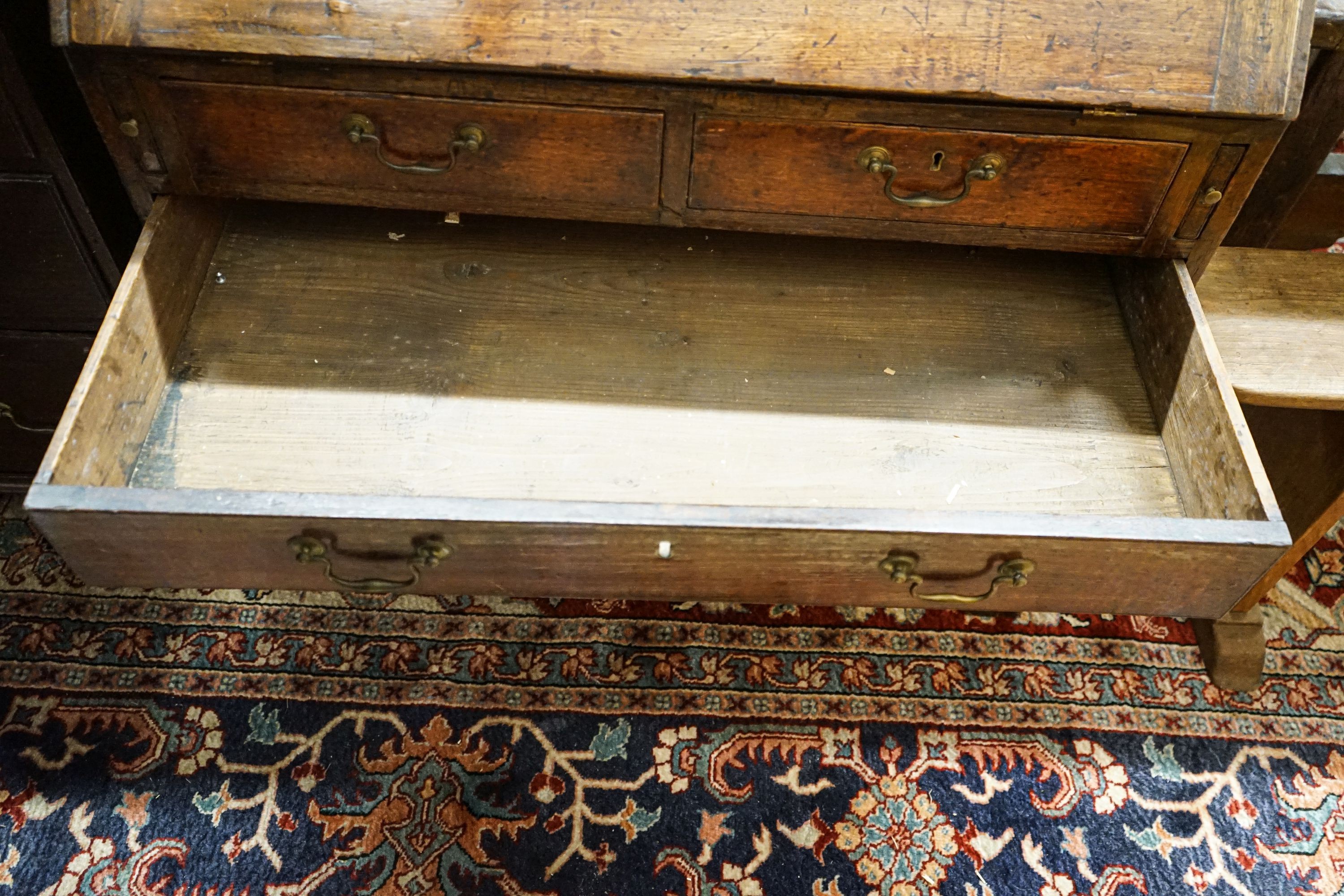 A George III oak bureau, with fitted interior, two short and three long drawers, width 92cm, depth 50cm, height 100cm